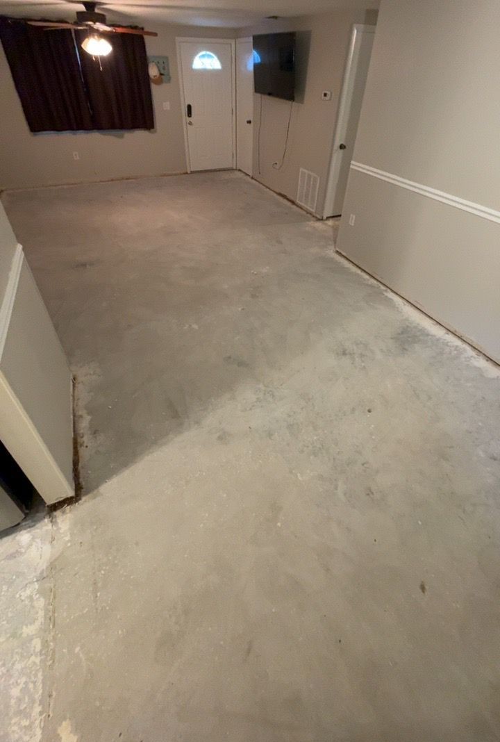 Bare concrete slab in a living room before flooring installation