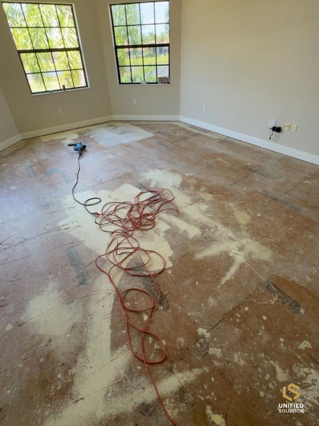 Old flooring removed and adhesive ground down before a new install