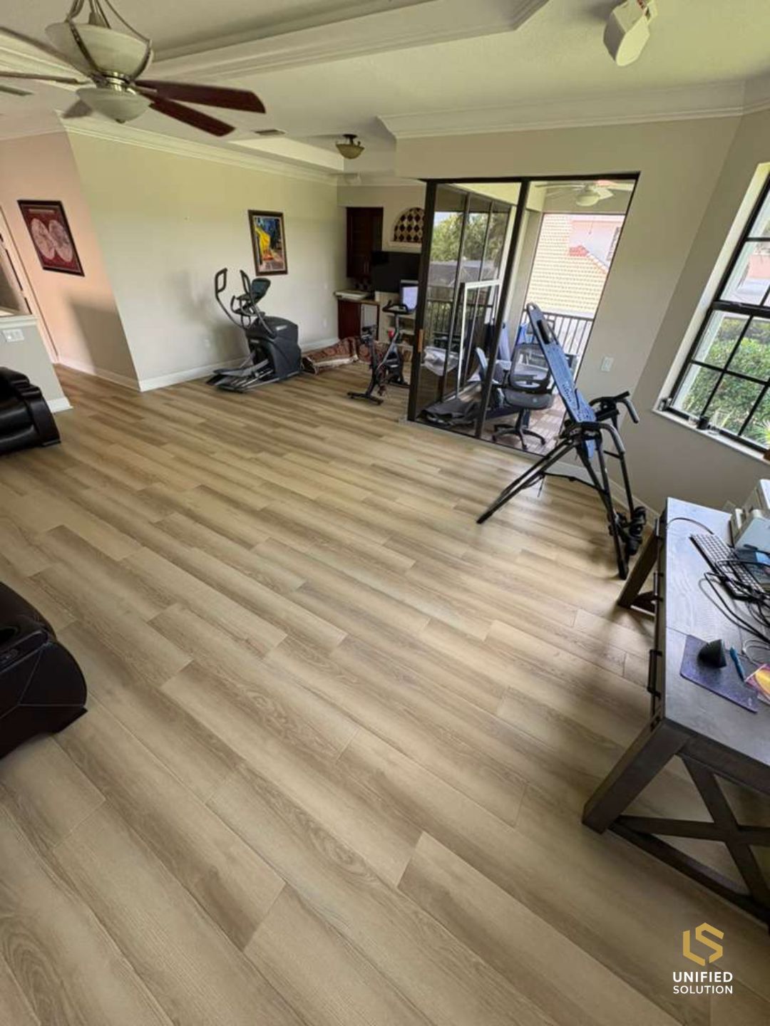 Wide continuous vinyl plank flooring running through a bright living space